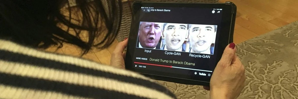 A woman watches a deepfake of Trump and Obama